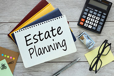 Estate planning notebook with a calculator and glasses for Nebraska asset protection.